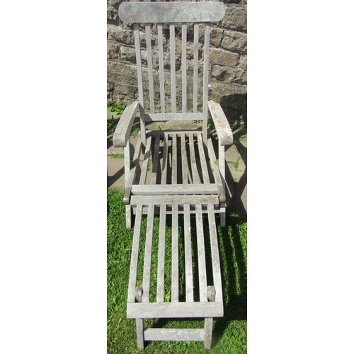 2052 - A pair of good quality weathered teak steamer style folding garden chairs with slatted seats, backs ... 