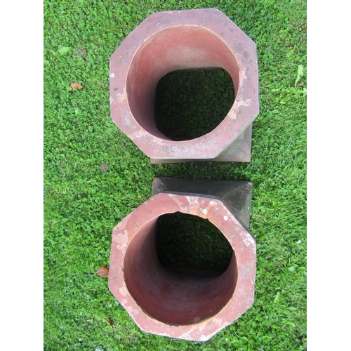 2059 - A pair of weathered chimney pots of squat octagonal and flared form, 42cm high