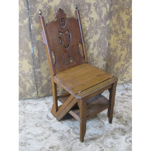 A Victorian oak metamorphic chair/library steps with a carved and panelled back
