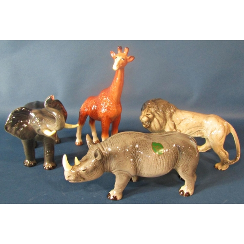 1025 - A Melba ware giraffe, rhinoceros, elephant and a lion