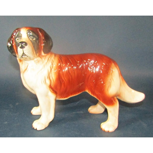 1028 - Four Melba ware dogs to include a Boxer, a Terrier, a Sheltie and a St Bernard