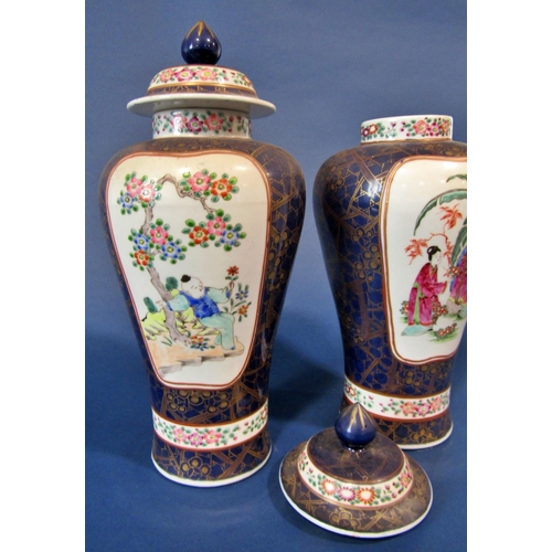 1063 - A pair of Chinese oviform vases and covers with character and foliate detail, set within blue and gi... 