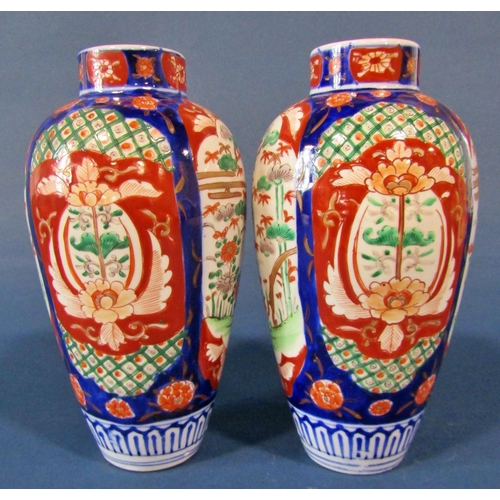 1073 - A pair of 19th century Imari shouldered vases with typical landscape and foliate detail, 25cm high