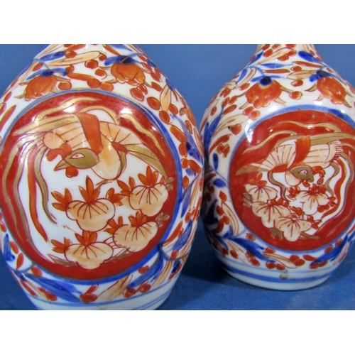 1083 - A pair of 19th century Imari gourd shaped vases with blue and red repeating floral decoration, 19cm ... 