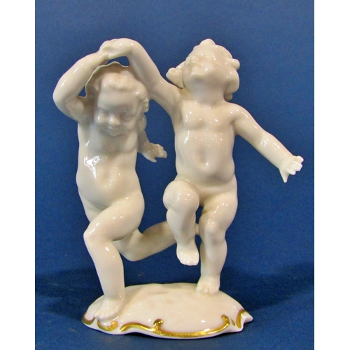 1120 - Kunstabteilung porcelain cherub in dancing pose, together with a further small 19th century group of... 