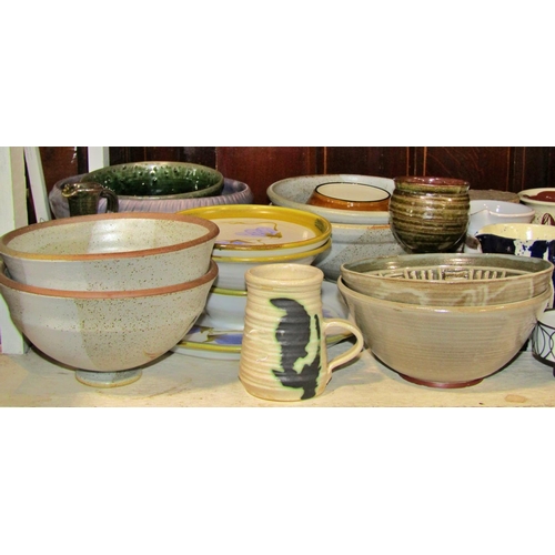 1160 - A large collection of studio pottery ware, various potters to include stemmed dishes, jugs and bowls... 