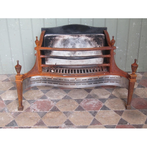 2075 - A Georgian style fire basket with serpentine front and pierced grill beneath urn finials, 77 cm x 50... 