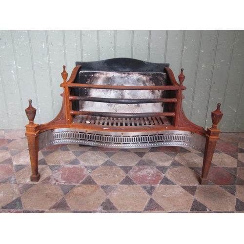 2075 - A Georgian style fire basket with serpentine front and pierced grill beneath urn finials, 77 cm x 50... 