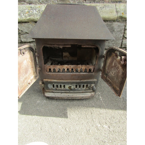 2100 - A cast iron wood/log burning stove, 62cm high x 60cm wide x 50cm deep