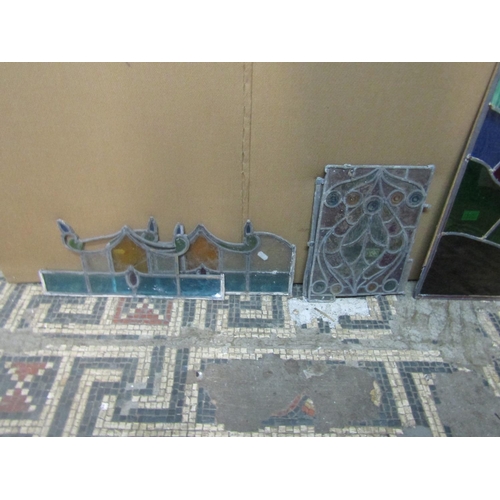 2107 - A group of leaded stained glass window sections, the largest panel measuring 80 x 52 cm (group)