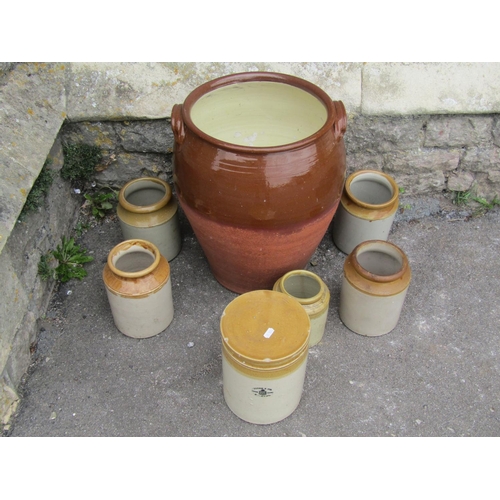 2117 - A terracotta storage jar, partially glazed with lug handles, 45cm high, together with six salt glaze... 