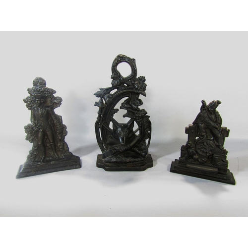 Three Victorian cast iron doorstops in order of size, a fox hunting theme, an 18th century soldier, and a bagpipe player, 30cm, 25cm, and 20cm.