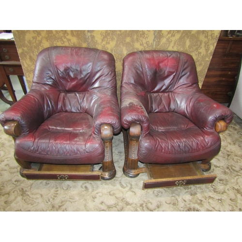 2175 - A pair of oak framed drawing room chairs with carved detail, maroon coloured upholstery