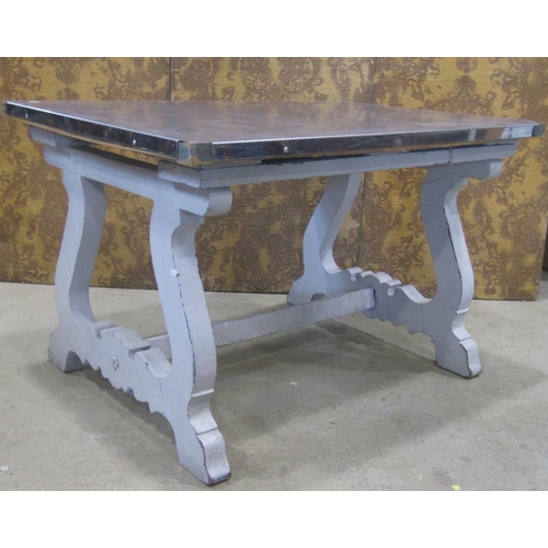 2201 - A continental kitchen table, the painted timber frame with shaped supports and central rail, beneath... 