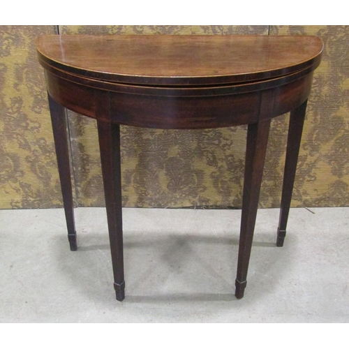 2236 - Georgian mahogany demi-lune fold over top tea table on square taper legs 81 cm diameter