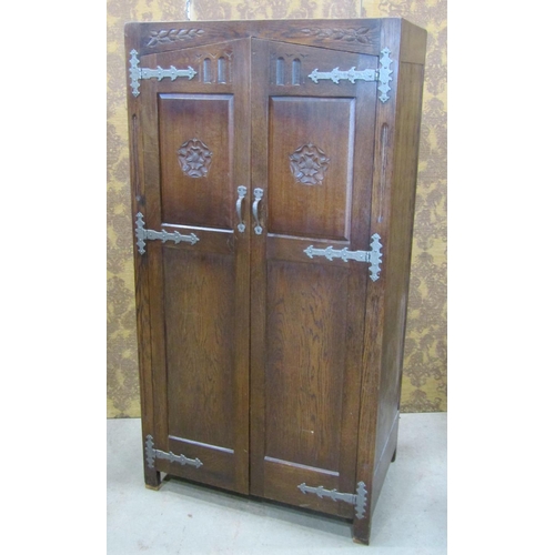 2243 - An old English style oak wardrobe with Tudor Rose detail, applied iron work set within a panelled fr... 