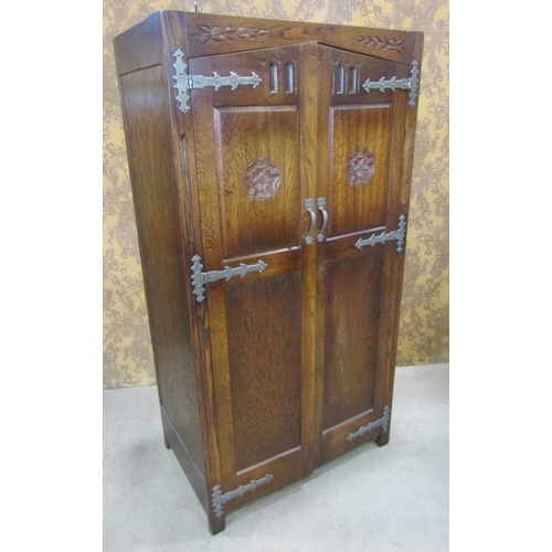 2244 - A pair old English style oak wardrobe with Tudor Rose detail, applied iron work set within a panelle... 