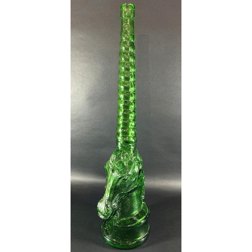 1204 - A tall green glass bottle in the form of a unicorn with spiral neck, 69.5cm high