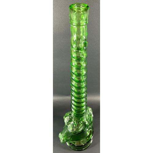 1204 - A tall green glass bottle in the form of a unicorn with spiral neck, 69.5cm high