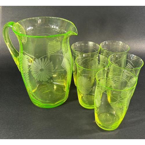 1226 - A Uranium glass lemonade jug and five glasses etched with summer flowers, five art deco style gilded... 