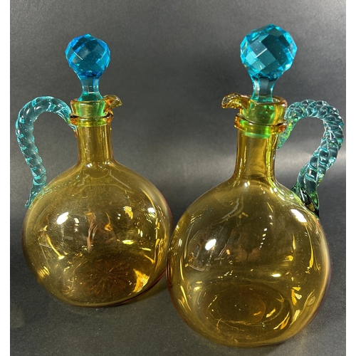 1229 - A pair of Scottish Amber Holyrood glass claret jugs c.late 1800, together with a Victorian cut glass... 