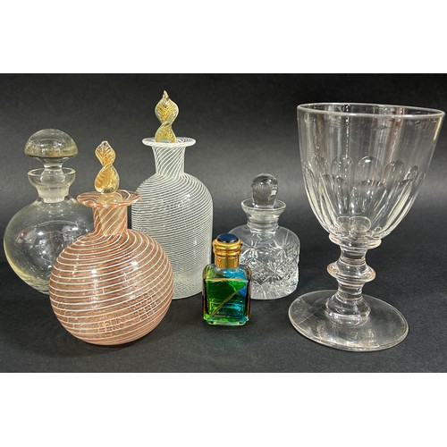 1243 - A mixed selection of items to include a single wine glass, three scent bottles, a collection of enam... 