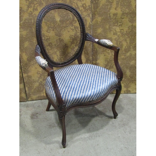 2342 - A Georgian mahogany chair frame with cameo back, open arms, serpentine seat on cabriole forelegs wit... 