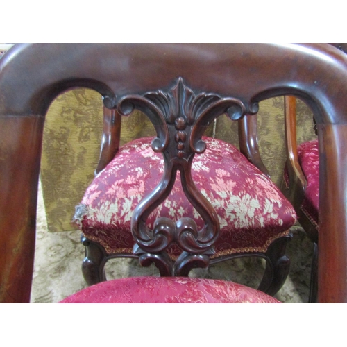 2346 - A set of six Victorian mahogany dining chairs with horseshoe shaped backs, carved and pierced splats... 