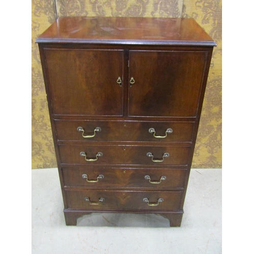 2300 - A small Georgian style cabinet, the lower section enclosed by four drawers, the upper section by two... 