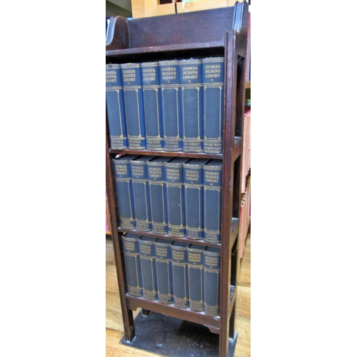 185 - A bespoke oak bookcase containing, 18 volumes of Charles Dickens