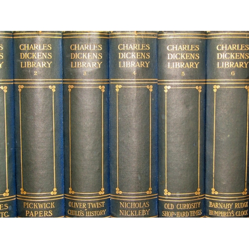 185 - A bespoke oak bookcase containing, 18 volumes of Charles Dickens