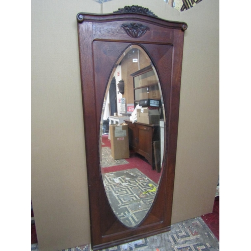 2400 - An early 20th century continental oak wall mirror with carved floral  pediment plate, 184 cm x 74 cm... 