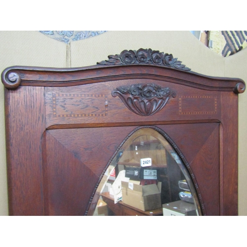 2400 - An early 20th century continental oak wall mirror with carved floral  pediment plate, 184 cm x 74 cm... 