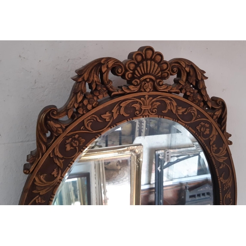 2402 - An oval gilt framed mirror in a Georgian style with acanthus, shell and other detail, 67 cm max toge... 