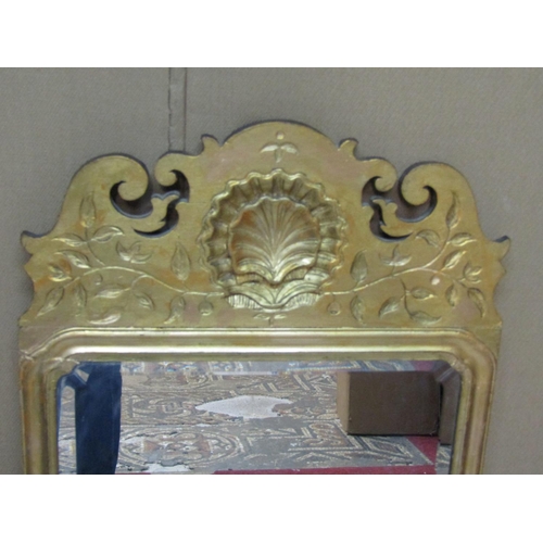 2420 - A George II style gilt framed pier glass the bevelled plate beneath a fret cut and shell-carved pedi... 