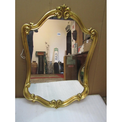 2421 - A scrolling gilt heightened frame wall mirror, 110 cm x 76 cm