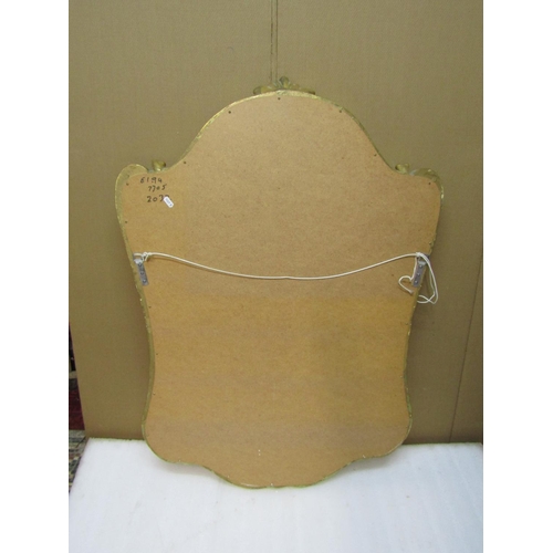 2421 - A scrolling gilt heightened frame wall mirror, 110 cm x 76 cm