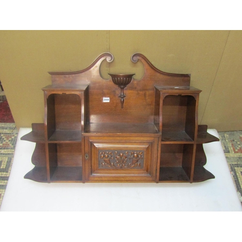 2432 - An Edwardian mahogany over-mantle wall hanging cabinet, fitted with single hinged carved panelled do... 