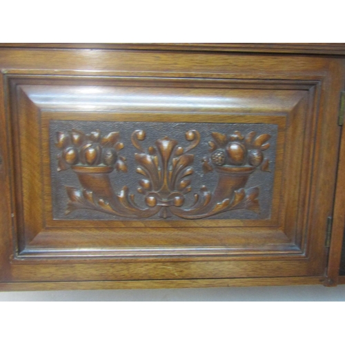 2432 - An Edwardian mahogany over-mantle wall hanging cabinet, fitted with single hinged carved panelled do... 