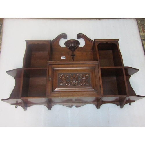 2432 - An Edwardian mahogany over-mantle wall hanging cabinet, fitted with single hinged carved panelled do... 