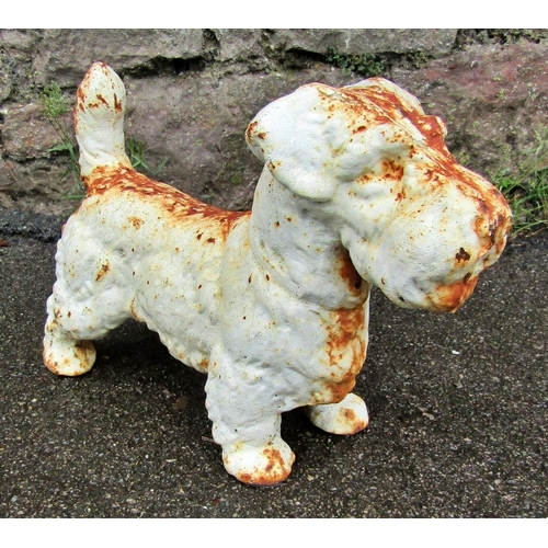 2066 - A small weathered cast iron garden ornament or door stop in the form of a standing terrier, 23cm hig... 