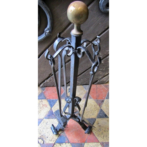 2091 - An ironwork fireside companion set with ball finial and scrolled supports, 68cm high