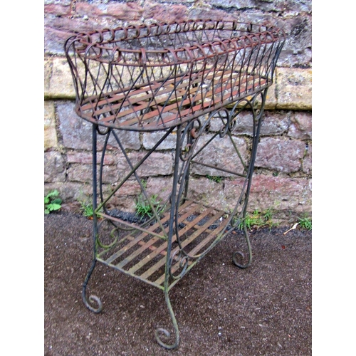 2094 - A good quality heavy gauge wirework garden/conservatory planter, on two open strapwork tiers, 52cm l... 