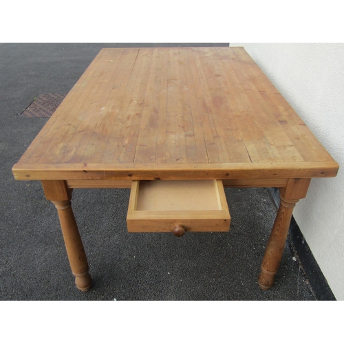 2464 - A contemporary stripped pine farmhouse kitchen table, the planked top raised on turned legs with two... 