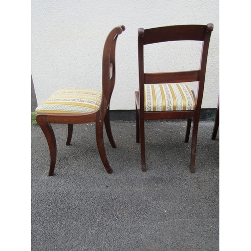 2465 - A set of six Victorian mahogany dining chairs with fluted back rails, raised on sabre legs