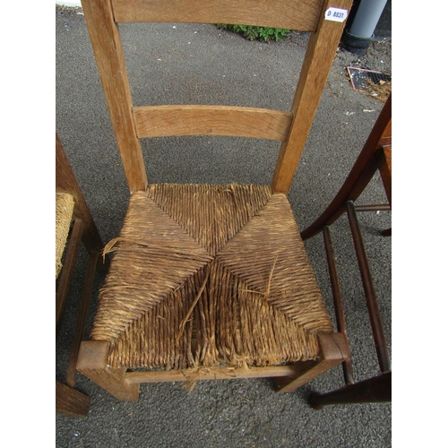 2470 - A child's oak elbow dining chair with rush seat together with a further child's dining chair, togeth... 