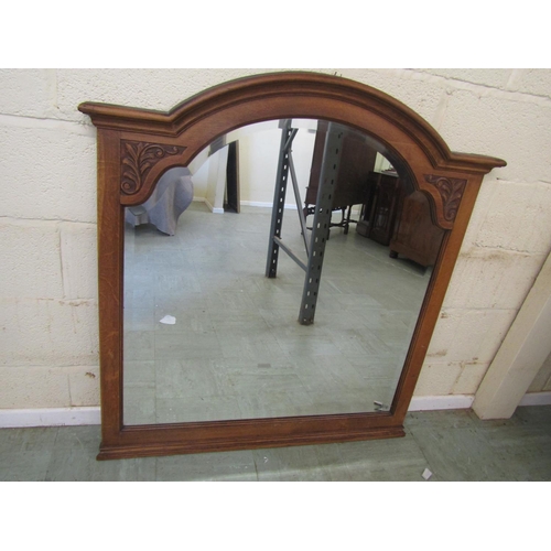 2476 - A continental carved oak over-mantle mirror, of arched form with  bevelled glass plate, 112 cm x 117... 