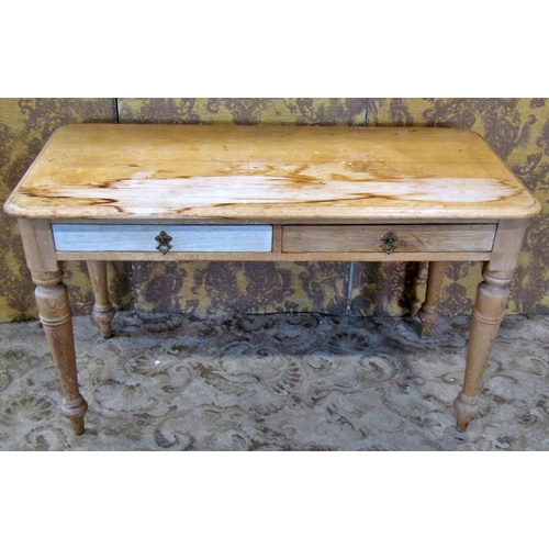 2302 - A Victorian stripped pine side table fitted with two drawers on turned supports, 112cm wide