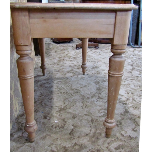 2302 - A Victorian stripped pine side table fitted with two drawers on turned supports, 112cm wide