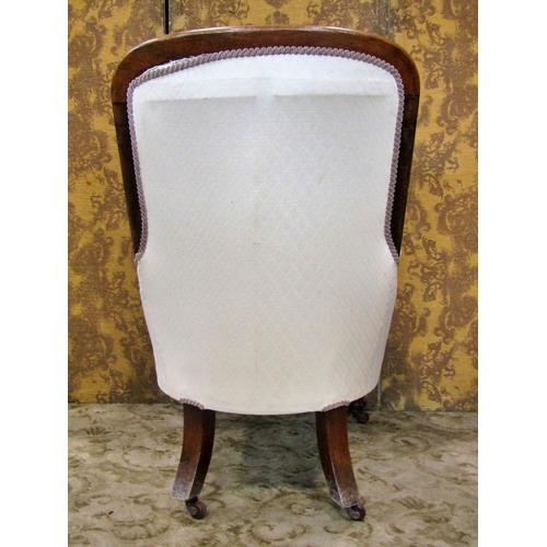 2311 - A Victorian mahogany framed drawing room chair with scrolled arms and upholstered framework